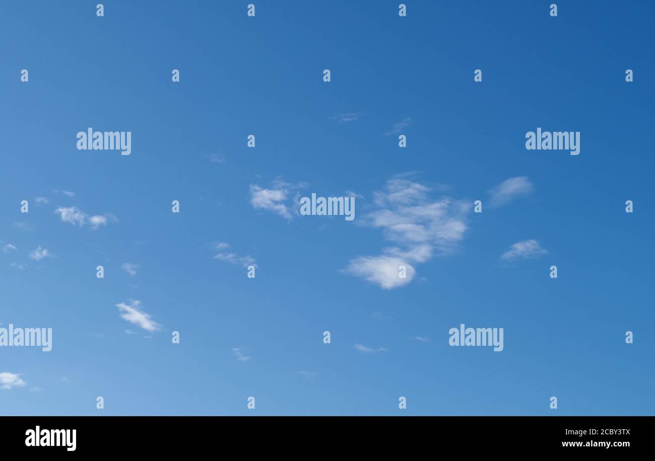 blue sky with a few clouds useful as a background Stock Photo - Alamy