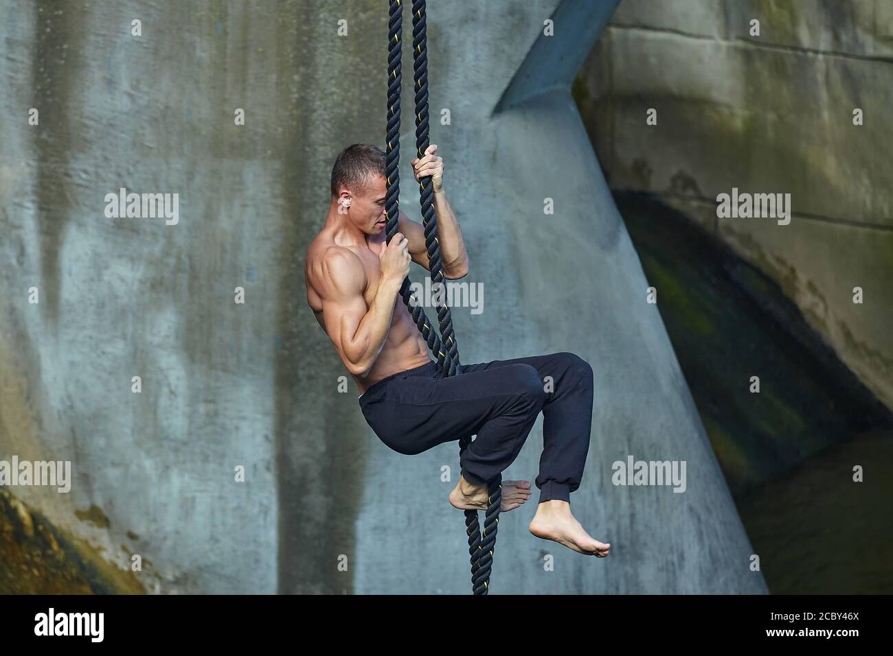 an athletic person performs dangerous exercises on a gymnastic rope. in