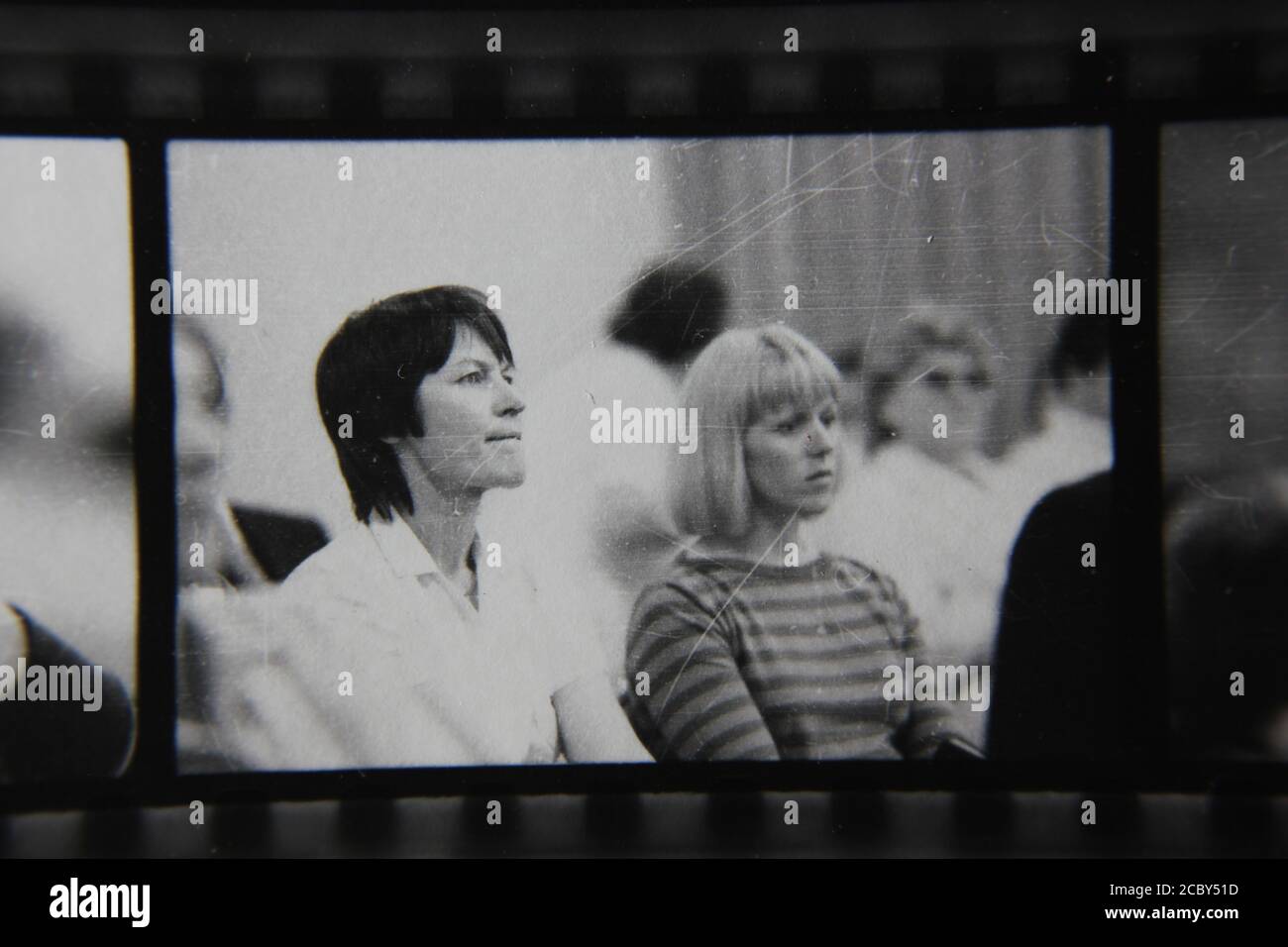 Fine 1970s vintage black and white photography of two women sitting in the audience paying attention to the entertainment. Stock Photo
