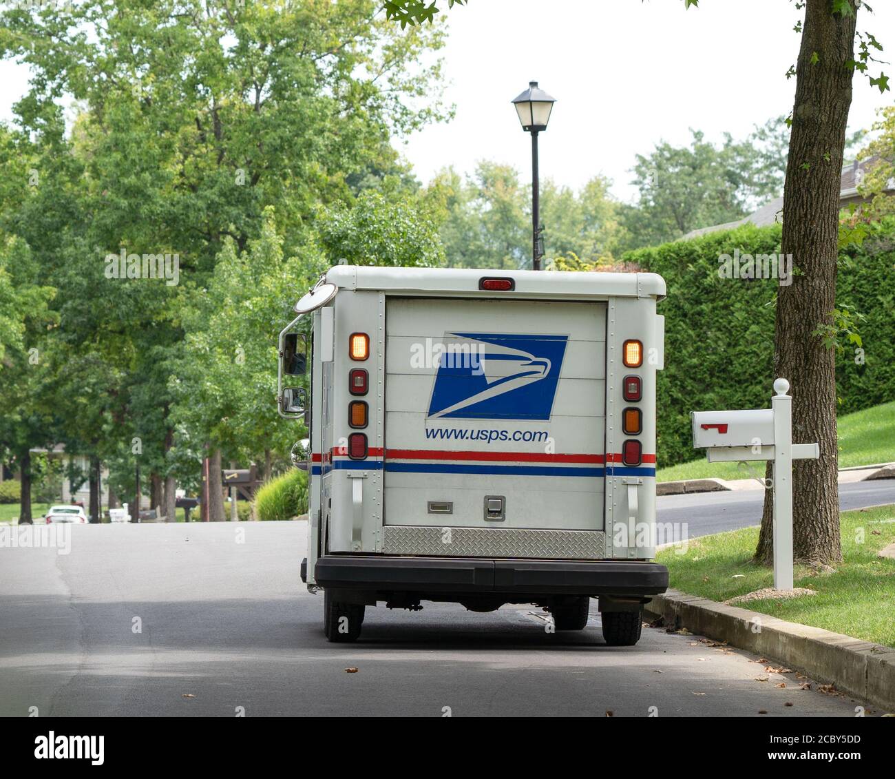 Berks County, Pennsylvania, USA-August 15, 2020: USPS truck delivering mail on suburban street in Pennsylvania. Stock Photo