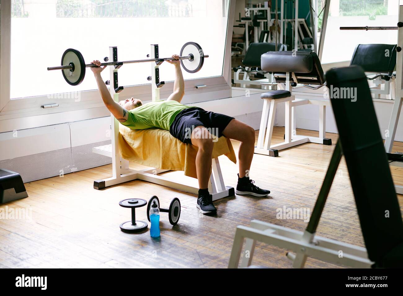 Bearded guy lifting weights at the gym Stock Photo