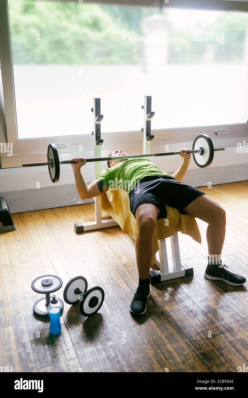 Bearded guy lifting weights at the gym Stock Photo