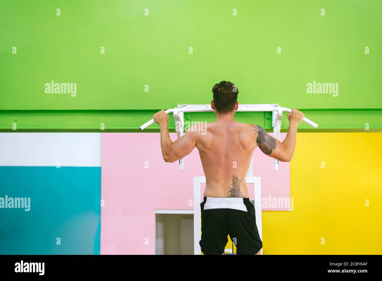 Muscular man workout doing pull ups on bar in gym,Man working out in a ...