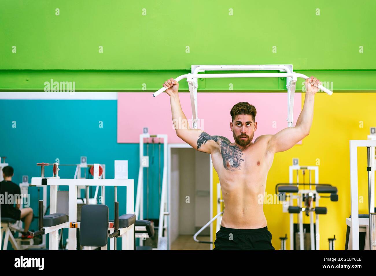 Muscular man workout doing pull ups on bar in gym,Man working out in a ...