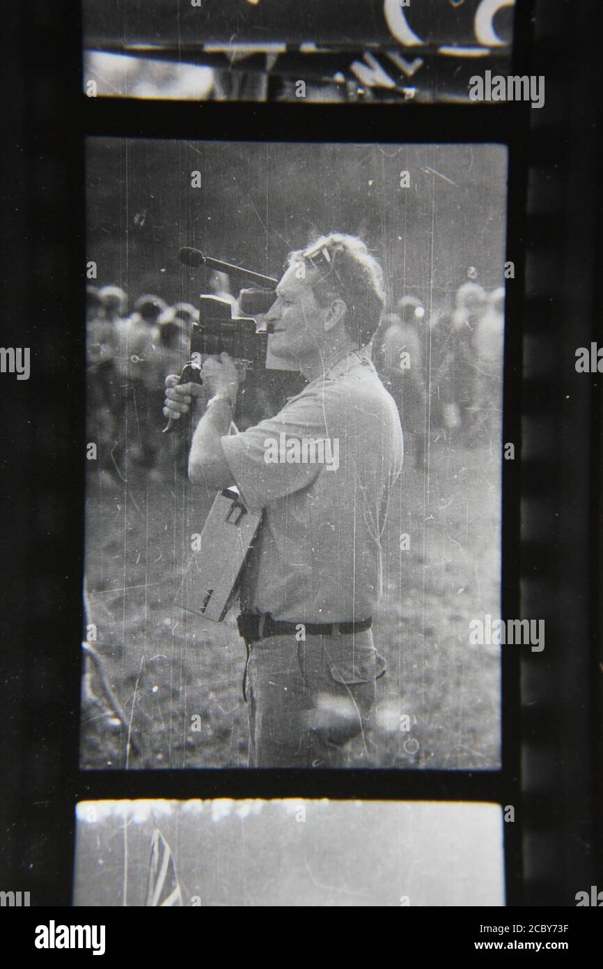 Fine 1970s vintage black and white photography of a photographer taking pictures of scouts enjoying summer scout camp. Stock Photo
