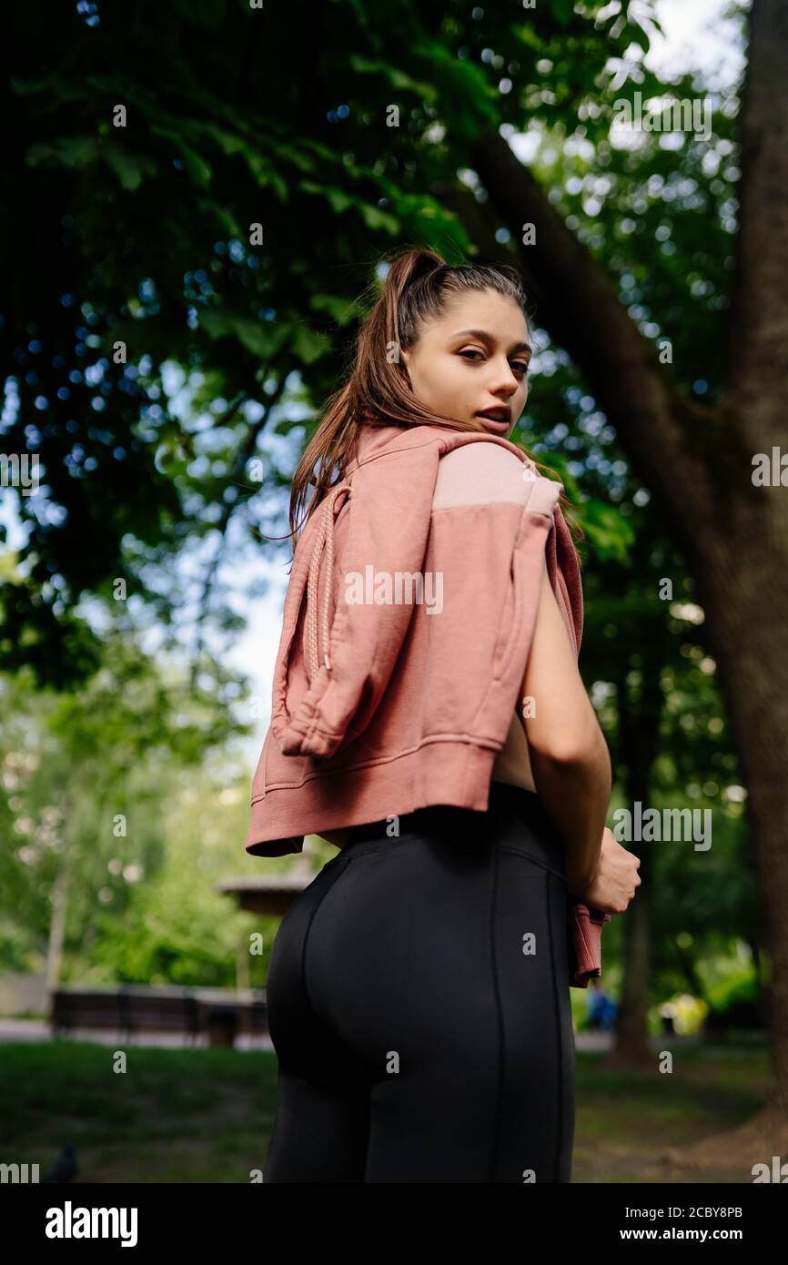 Young woman is resting after jogging in the park Stock Photo - Alamy