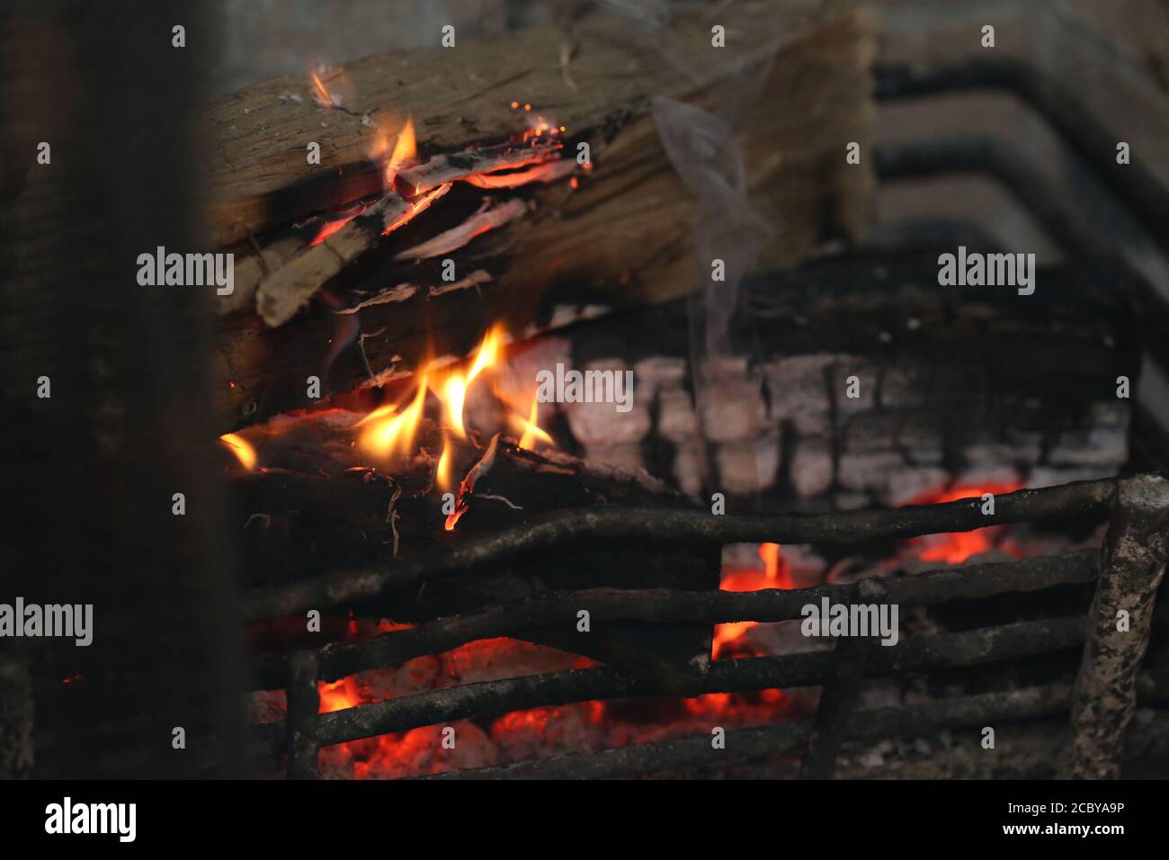 Camper feeds the nighttime bonfire Stock Photo