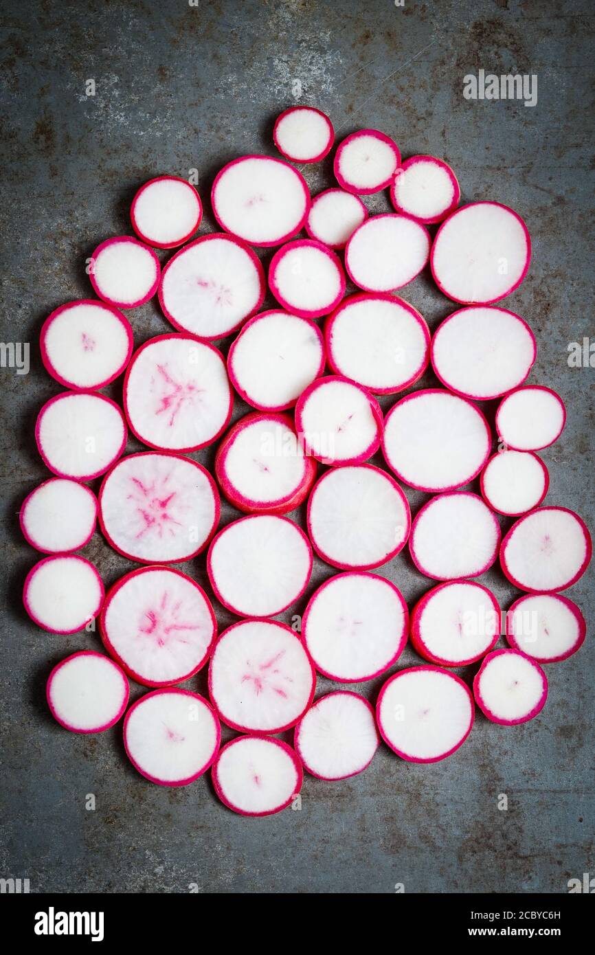 Fresh radishes on a dark surface Stock Photo