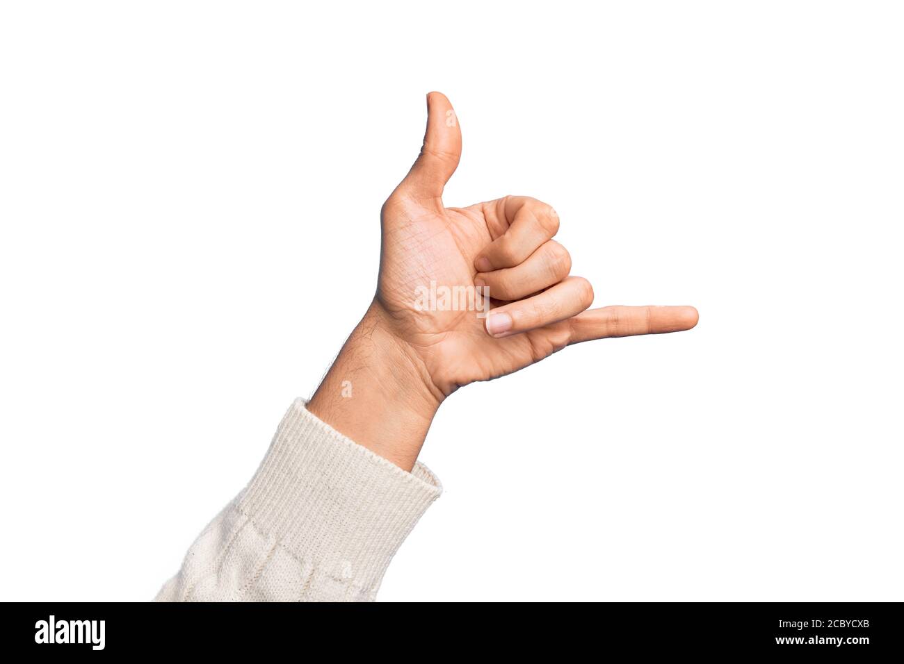 Hand of caucasian young man showing fingers over isolated white background gesturing Hawaiian shaka greeting gesture, telephone and communication symb Stock Photo