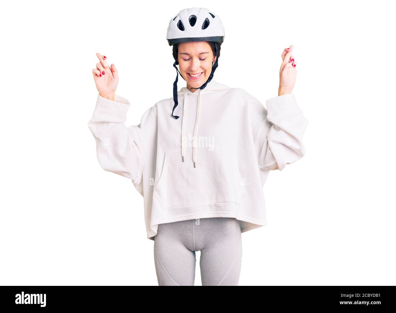 Beautiful young woman wearing bike helmet and sporty clothes