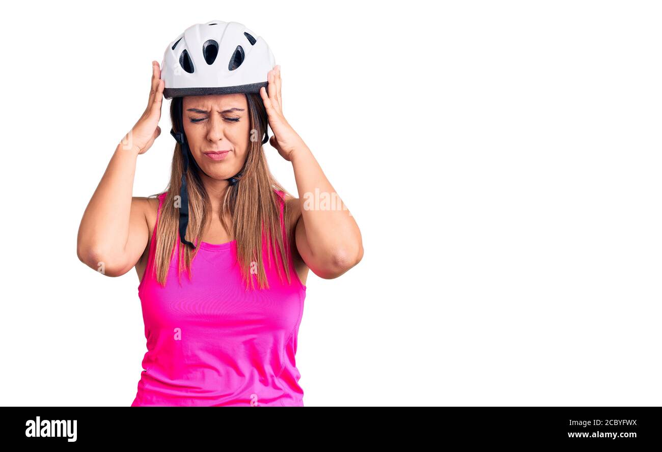 bike helmet headache Young beautiful woman wearing bike helmet suffering from headache desperate  and stressed because pain and migraine. hands on head Stock Photo