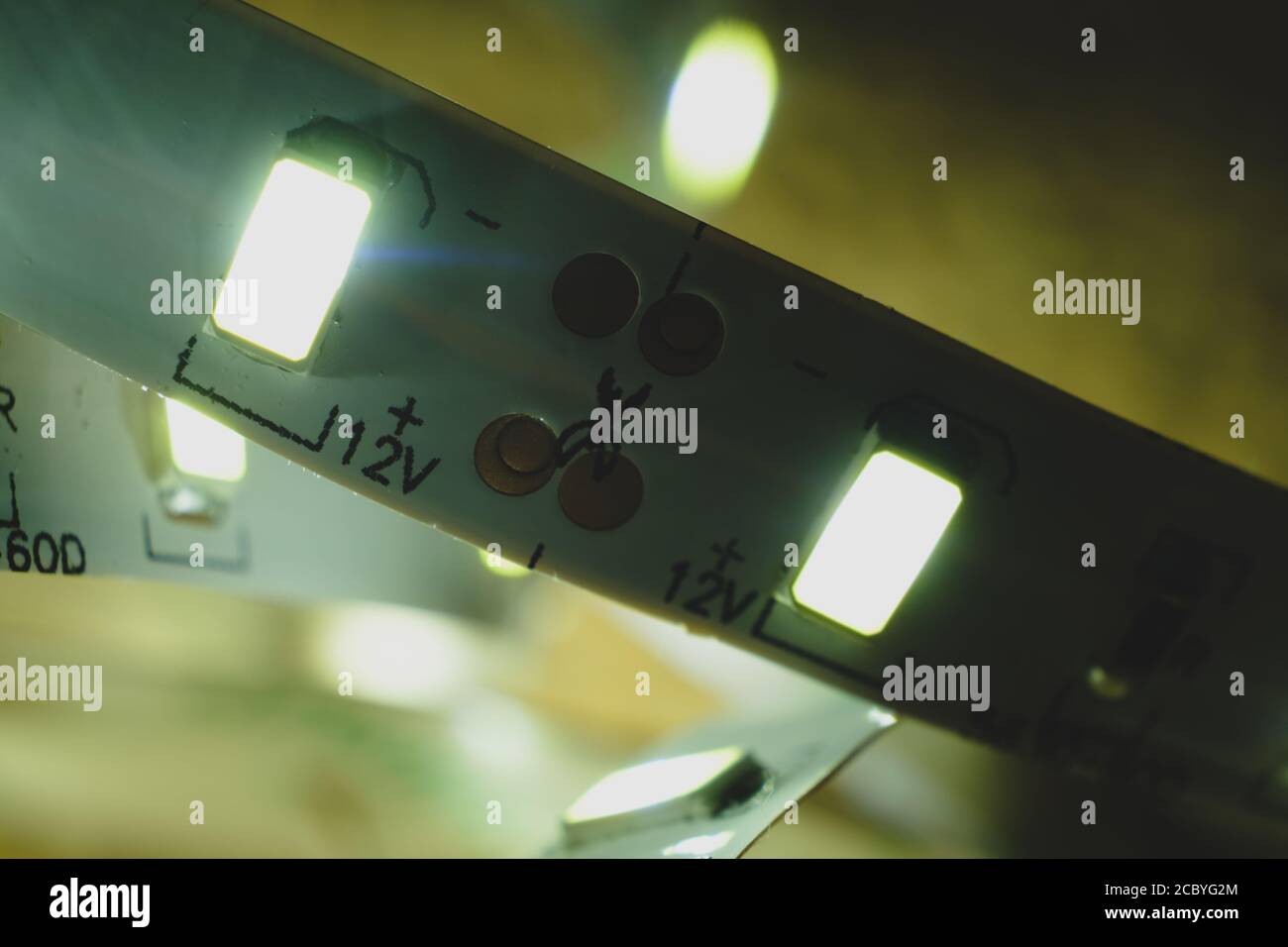 White led strip shining macro image. Modern light source 12V with marks ...