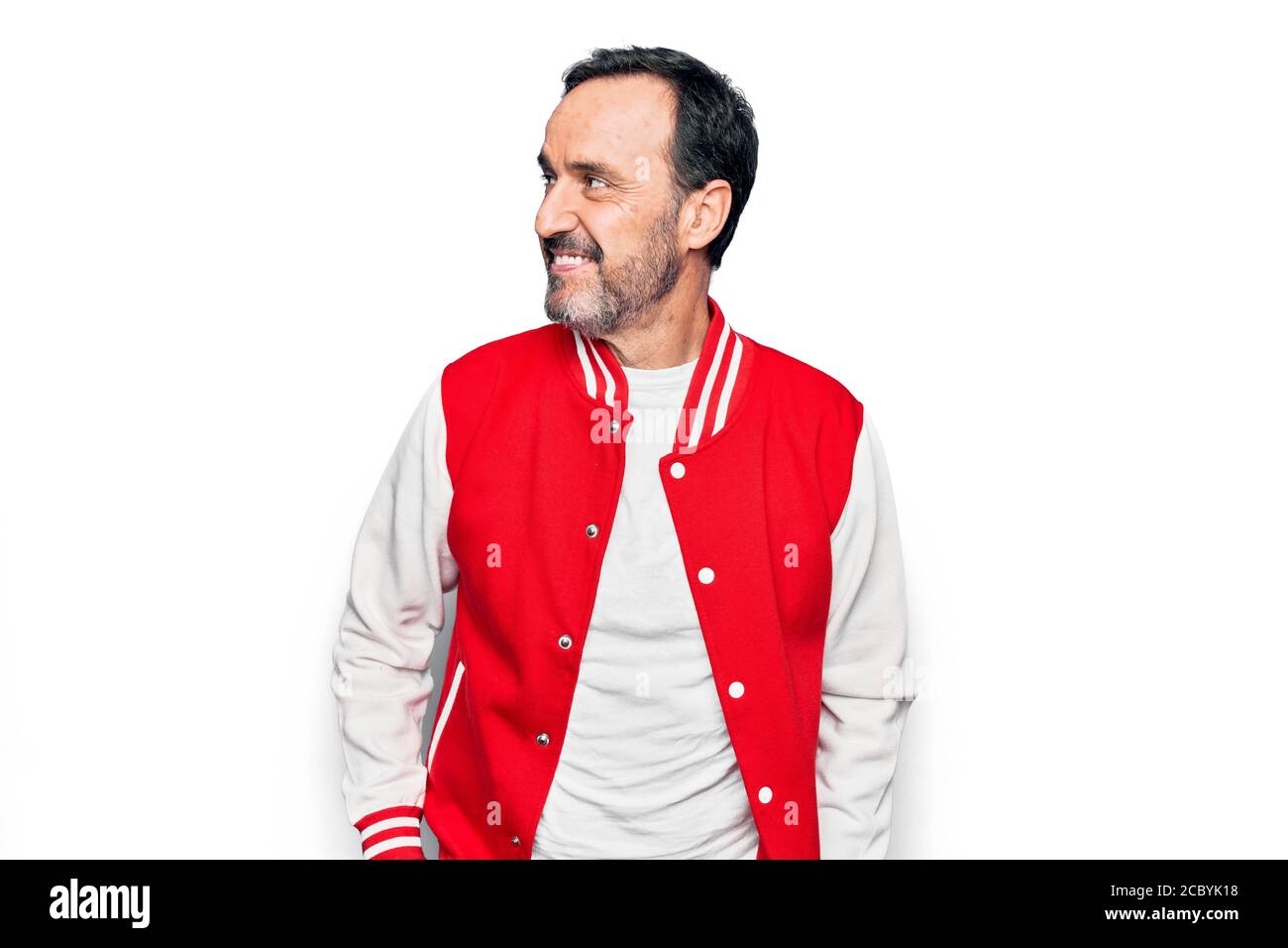 Middle age handsome man wearing baseball jacket over isolated white ...