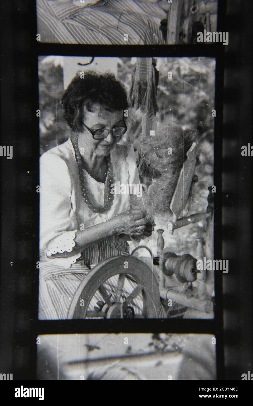 Fine 1970s vintage black and white photography of an older woman demonstrating her skills and talents at a scout camp. Stock Photo