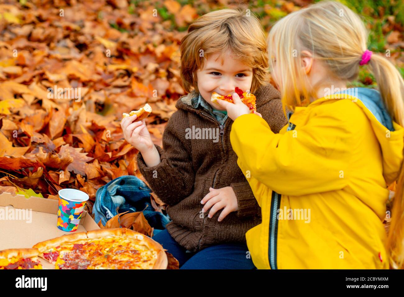 Kids favorite food. Children food concept, two happy hungry kids eating ...