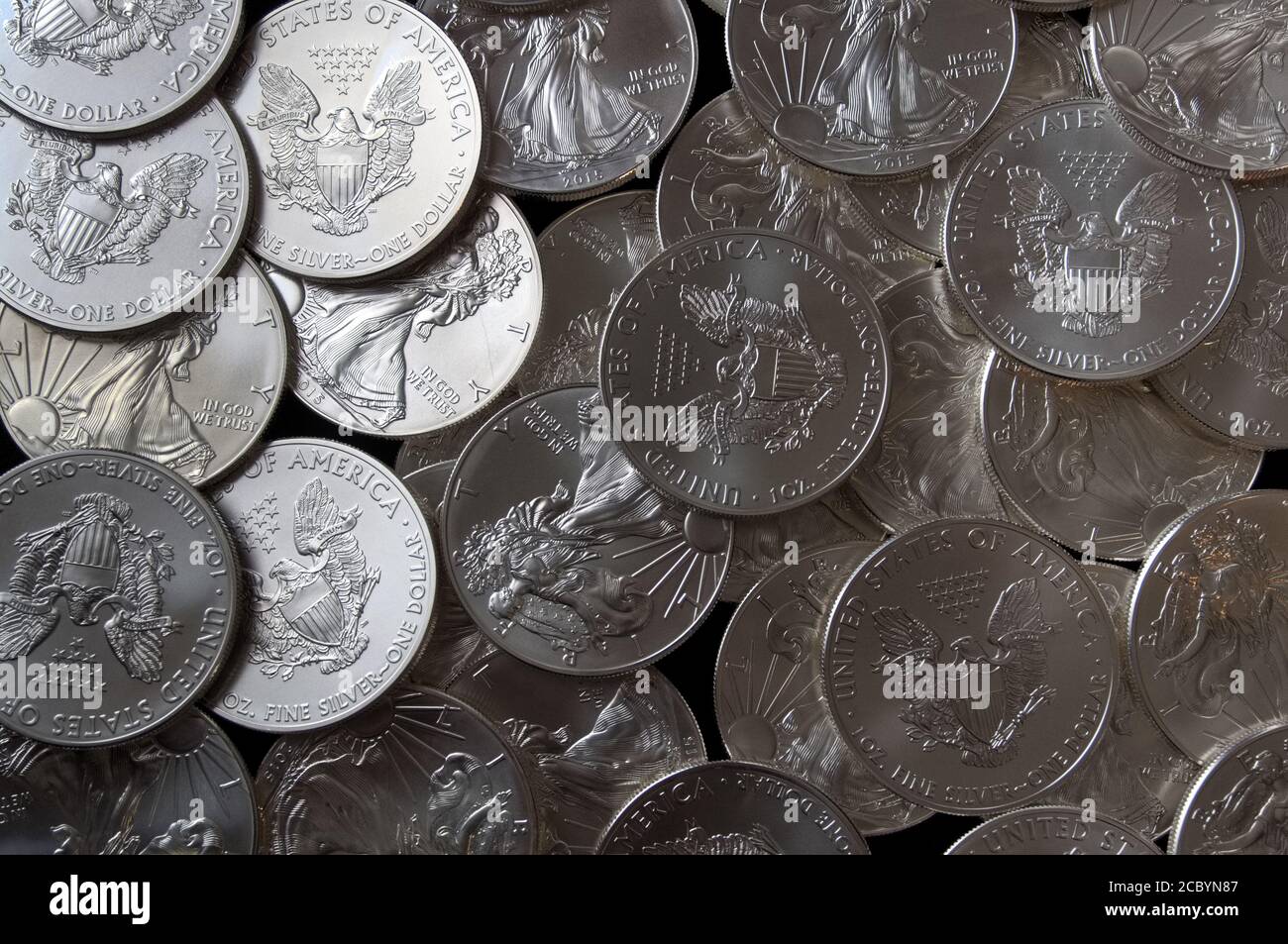 Pile of American Eagle silver dollar coins, with natural light from the