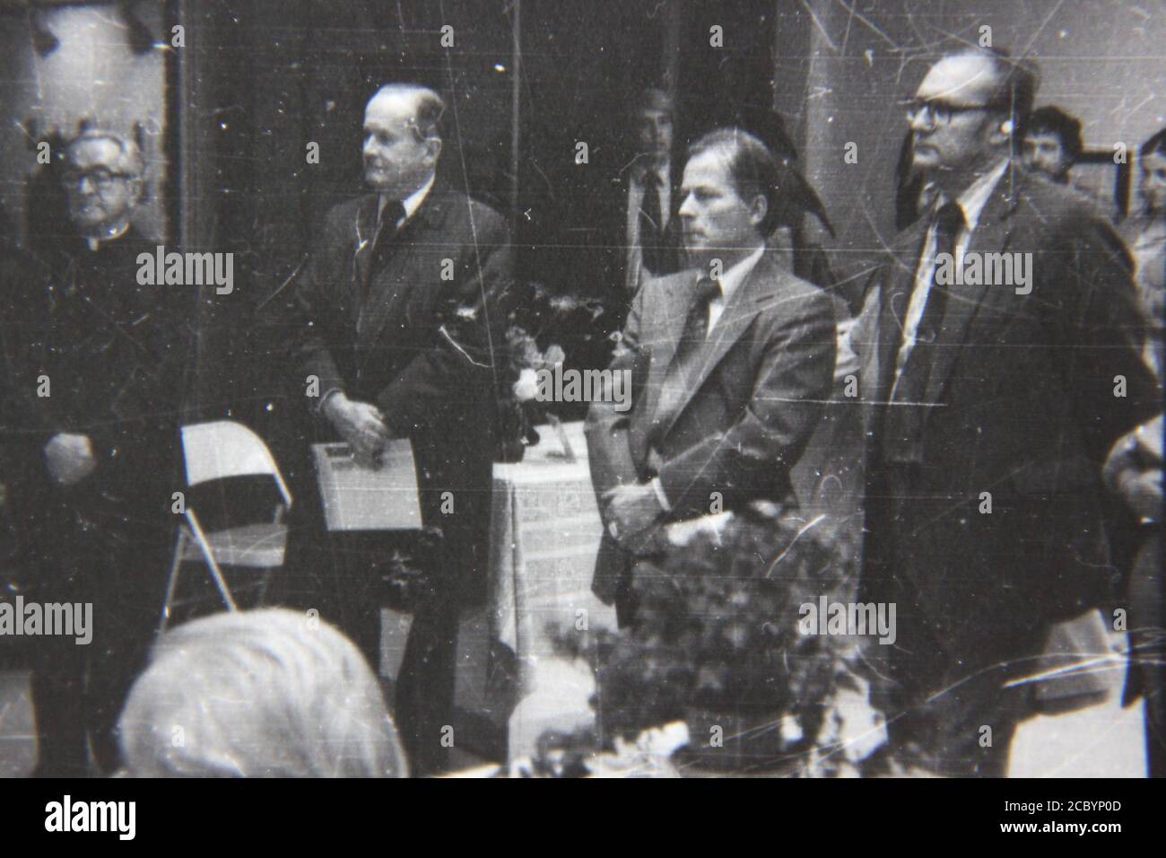 Fine 1970s vintage black and white photography of an office crowd listening to a lecture. Stock Photo