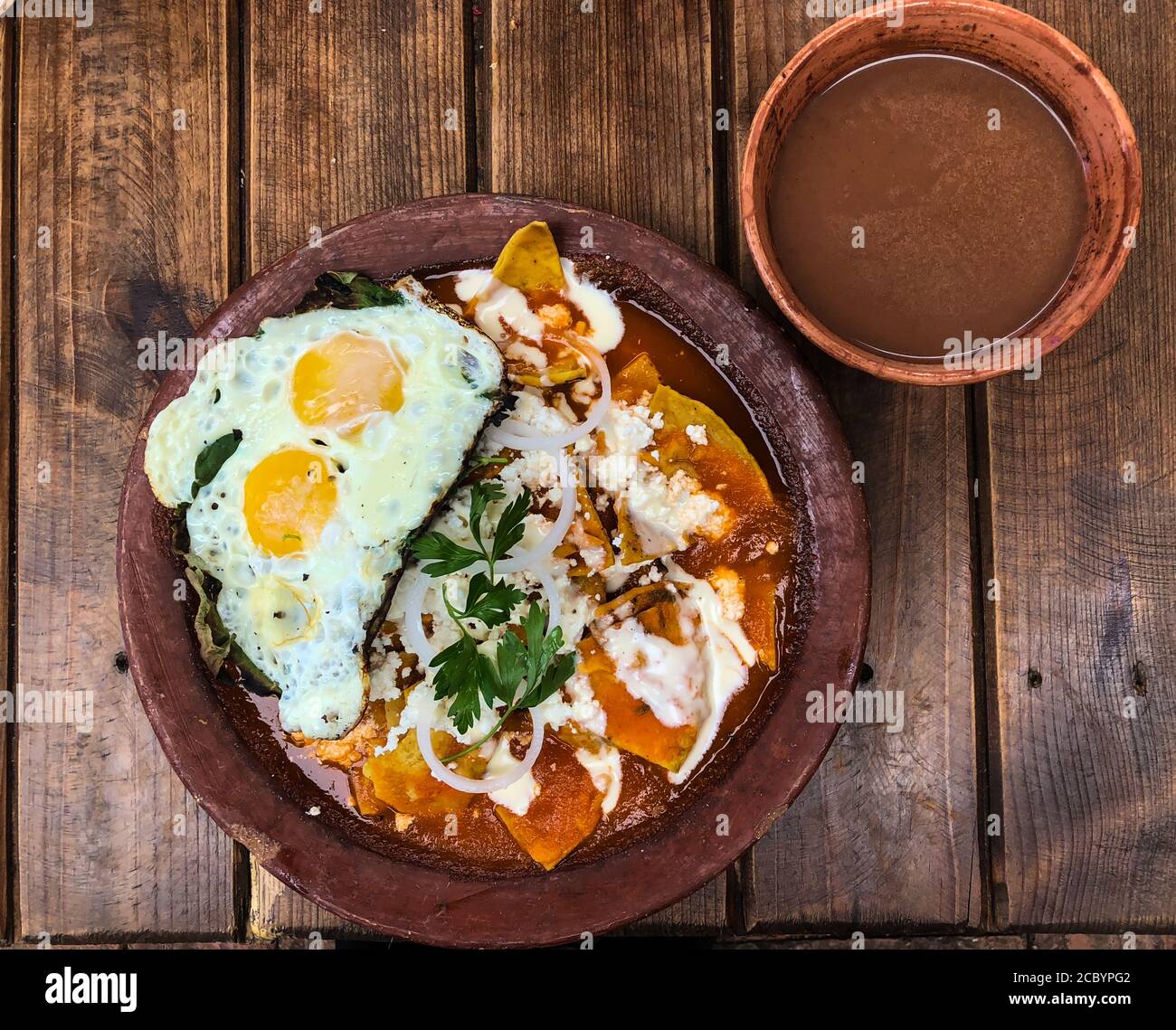 Chilaquiles with fried eggs and a bowl of atole champurrado is a