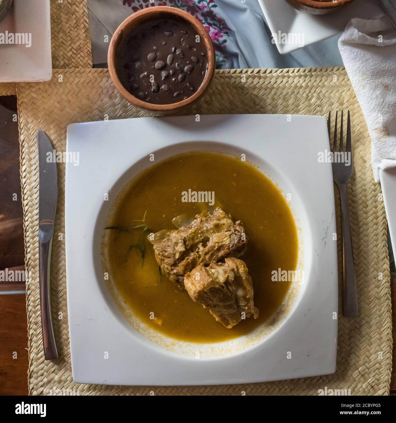 Costillas de puerco or pork ribs with black beans.  Oaxaca, Mexico. Stock Photo