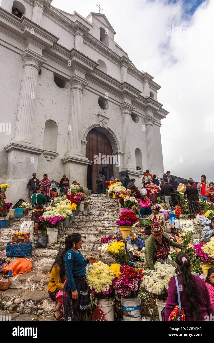 Quiche Mayan women selling flowers in the flower market on the pre-Hispanic Mayan steps in front of the Church of Santo Tomas in Chichicastenango, Gua Stock Photo