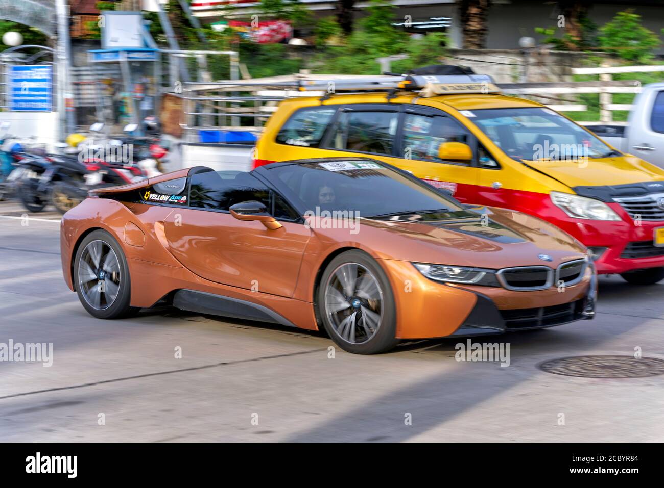 BMW i8 soft-top convertible 2+2 German plug-in hybrid supercar accelerating through traffic. Blur and motion, speeding Stock Photo