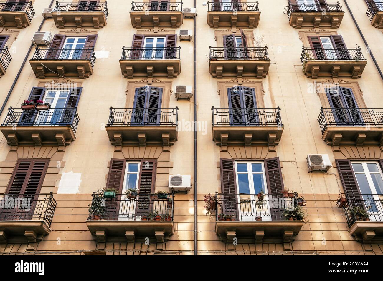 Building exterior with windows and balconies in Sicily, Italy Stock
