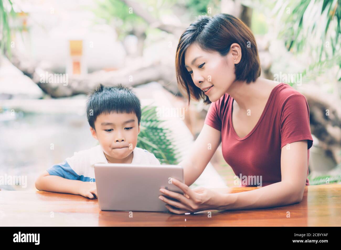 Son Using Digital Tablet Computer For Study And Learn To Internet Online With Mother Together Education From Home Family Recreation Mom Teach Boy W Stock Photo Alamy