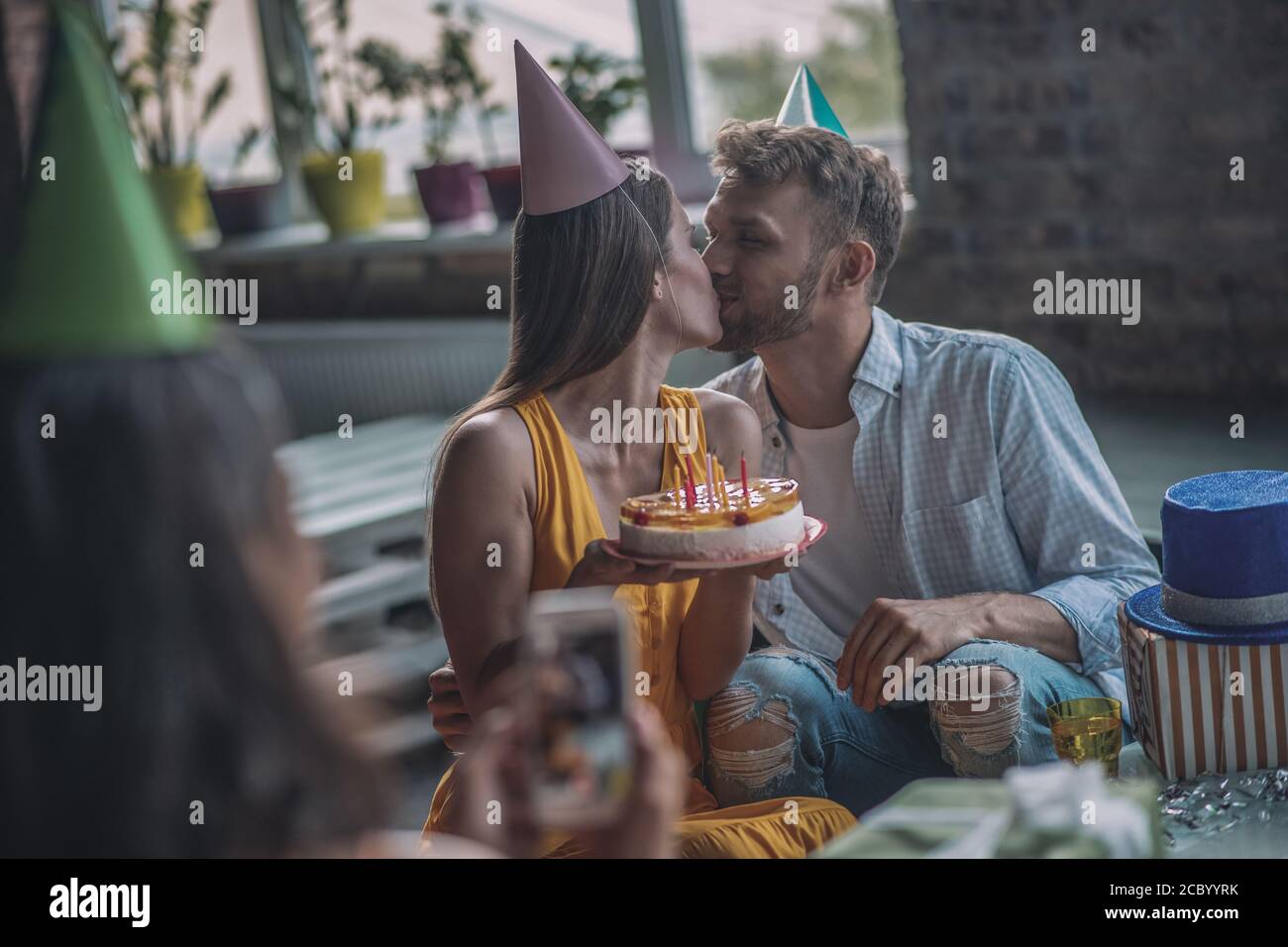 Couple kissing each other at the birthday party Stock Photo Alamy
