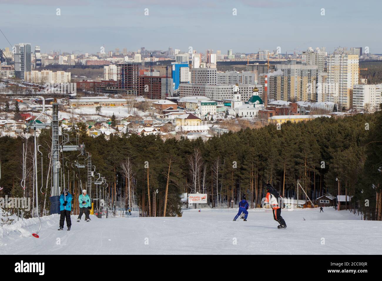 People on the ski slope and view of the city of Yekaterinburg Stock Photo