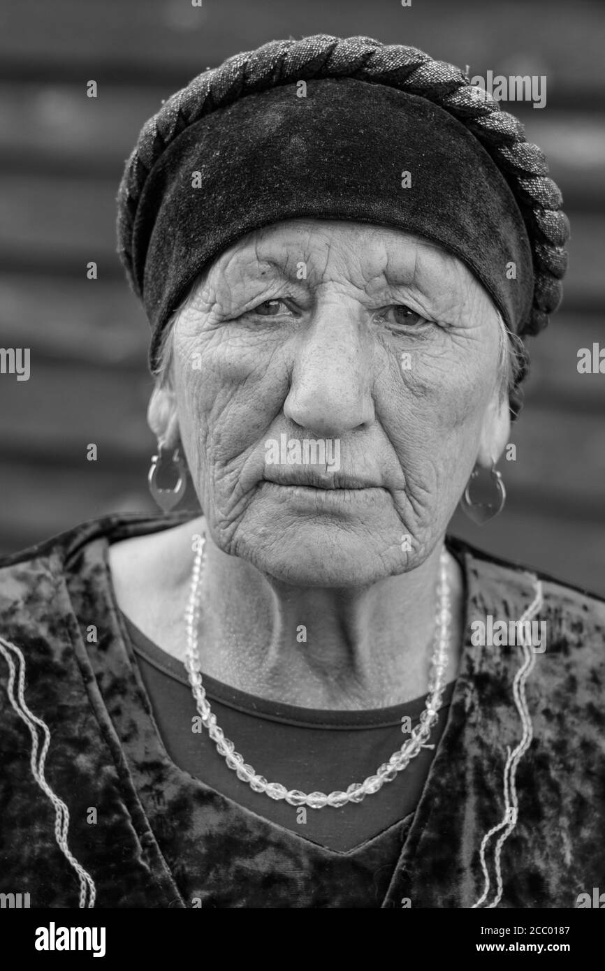 Russia Novoufimskaya May 26, 2018 Close-up black-white portrait of a village elderly woman in a national costume Stock Photo