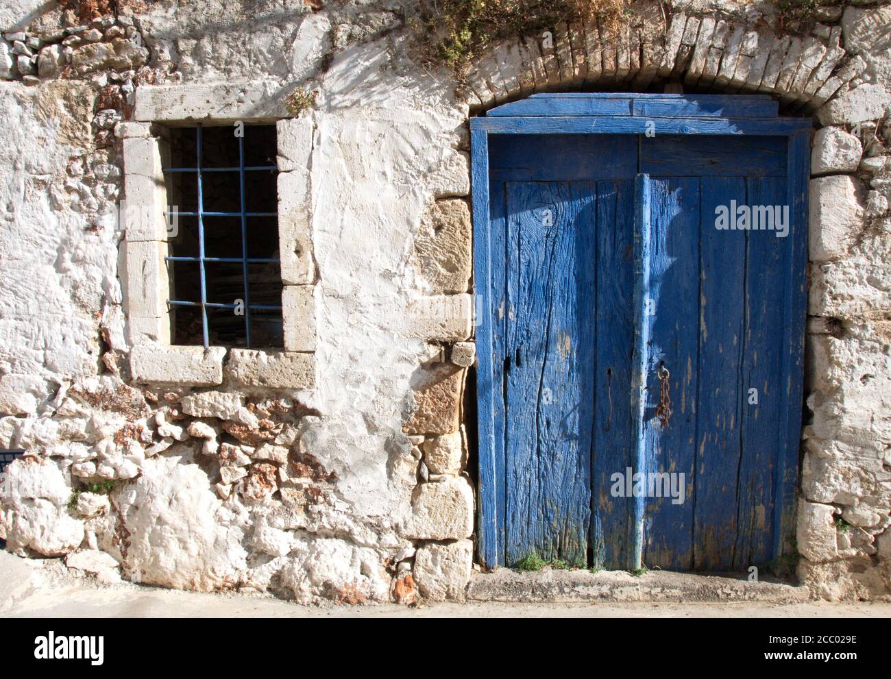 Traditional blue door and a window of a Greek village house Stock Photo ...