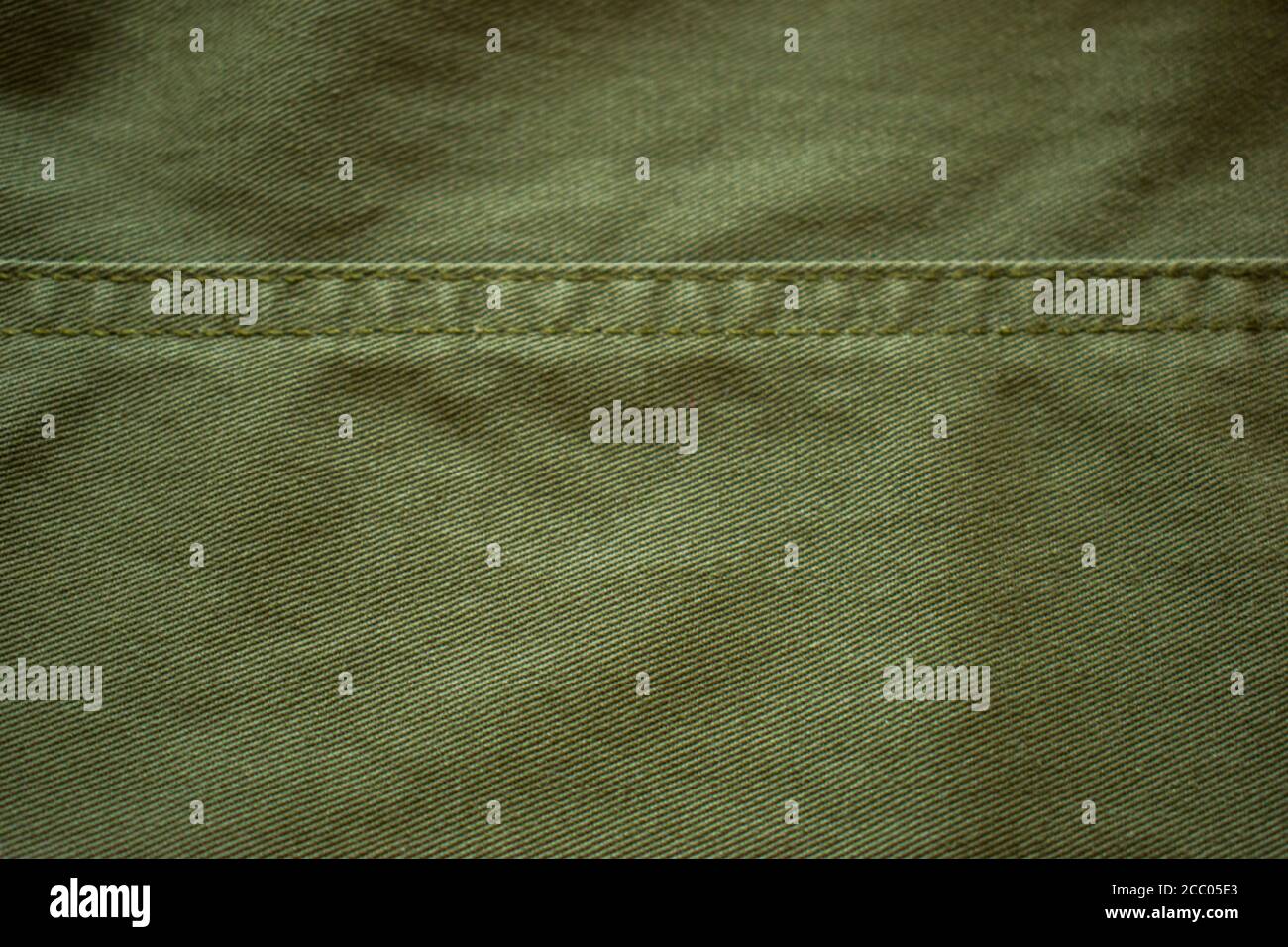 Background of green grunge military fabric, cloth with textures. Stock Photo
