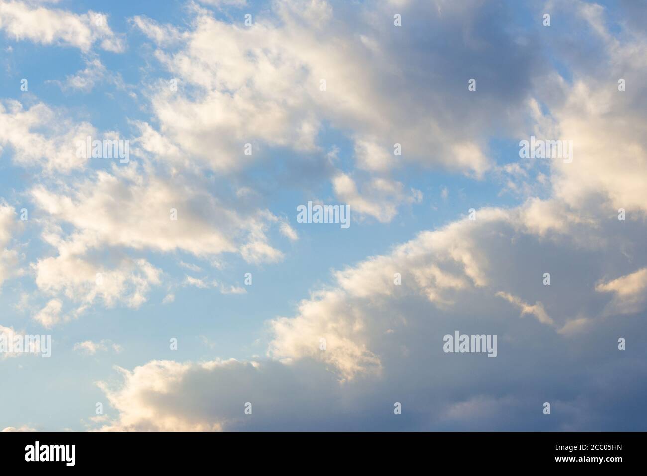 cloudy sky in yellow light. natural background at sunrise. inspiring scene Stock Photo