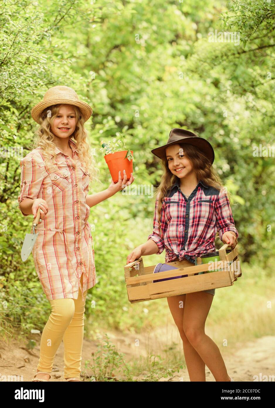 Making your life bright and colored. children work using gardening tool. small girls farmer in village. happy farming. spring country side. earth day. summer family farm. protect nature. Rich harvest. Stock Photo
