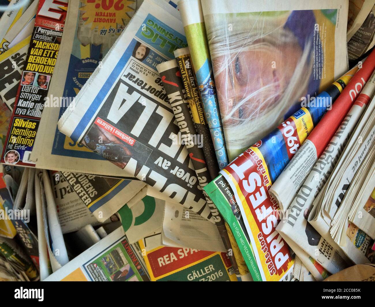 a lot of random accumulated Swedish journal newspapers and Magazines in close up view, papers trash recycling concept background. Stock Photo