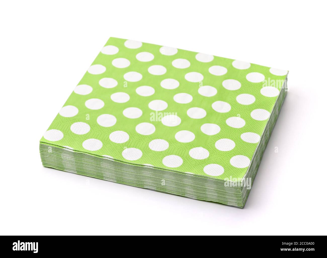 Stack of green dotted paper napkins isolated on white Stock Photo