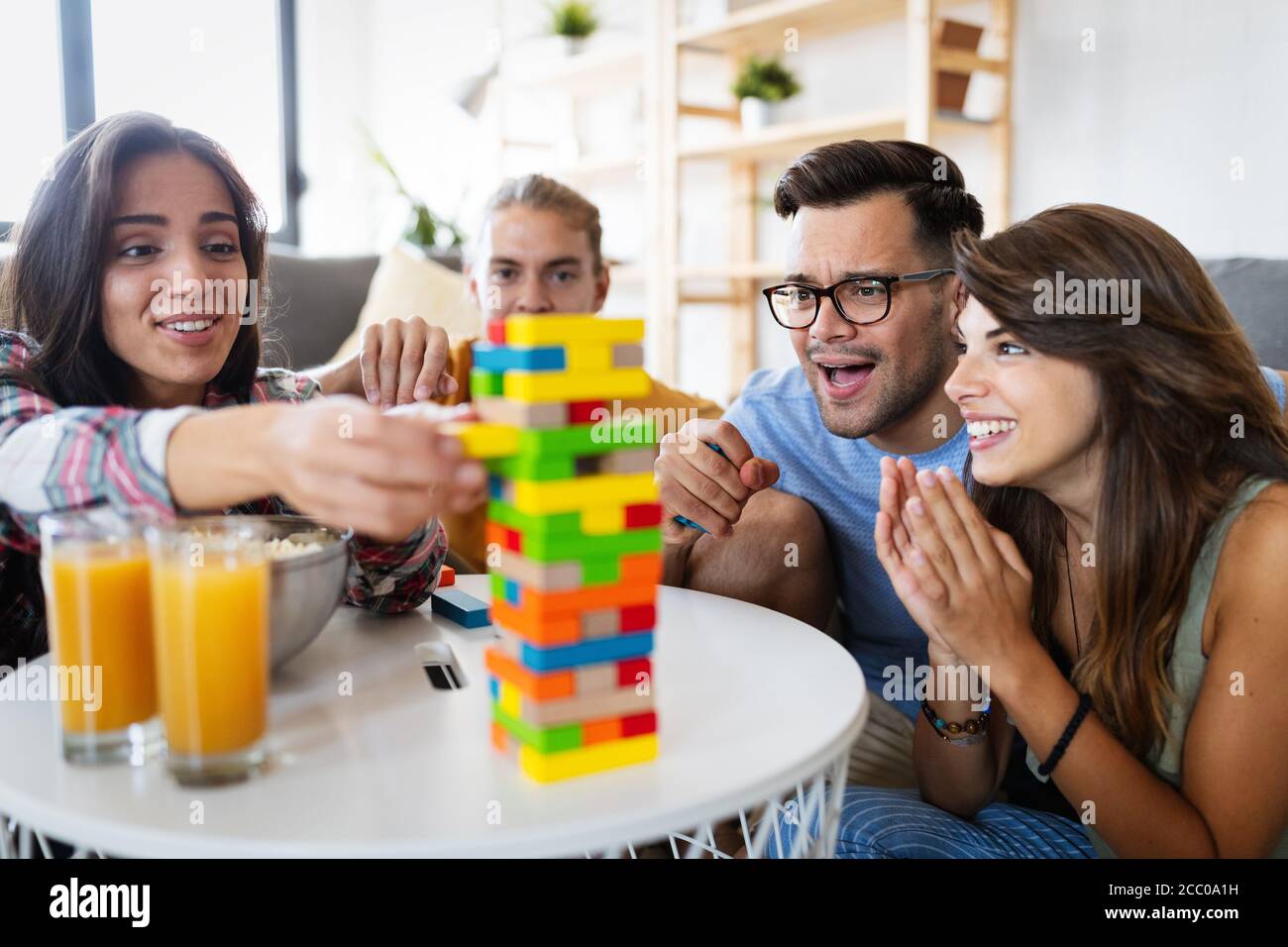 Happy group of friends have fun and playing board game together Stock ...