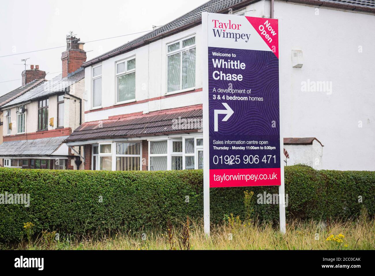 A sign shows directions to a housing development in Newton-le-Willows. Stock Photo