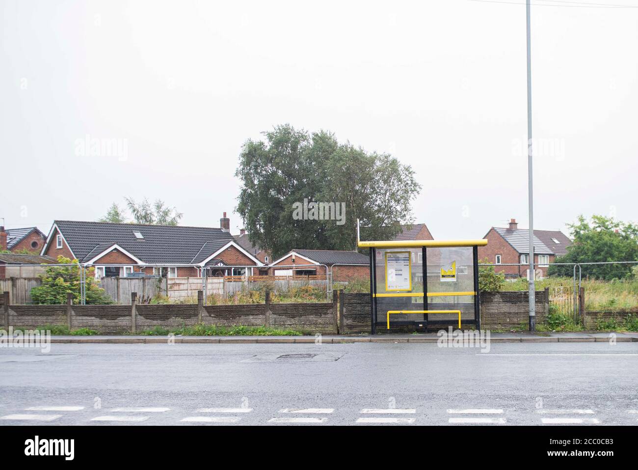 A bus stop sit in front of land for development. Stock Photo