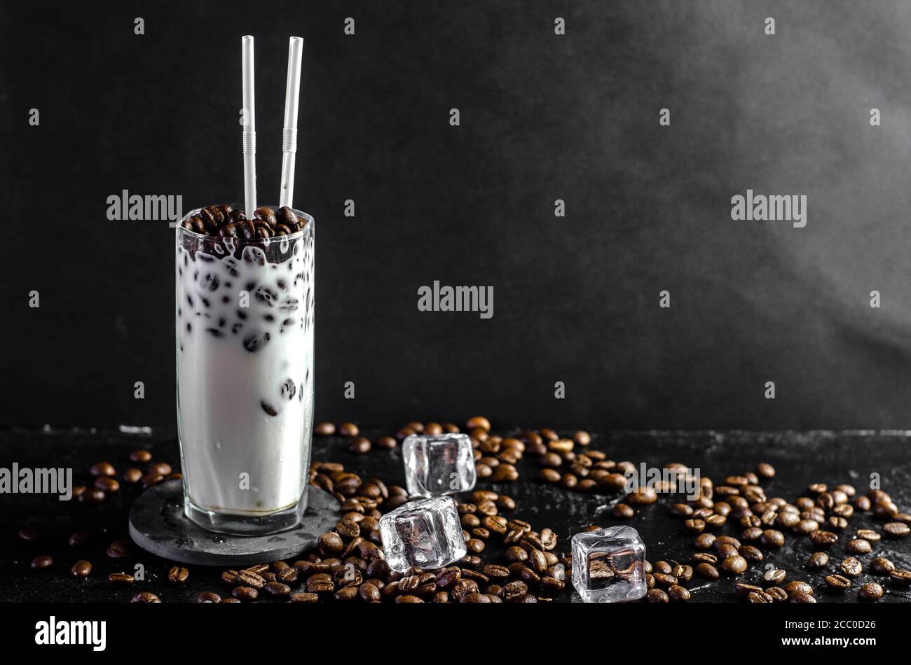 Iced coffee frappe with milk concept in a tall glass with the straws ...