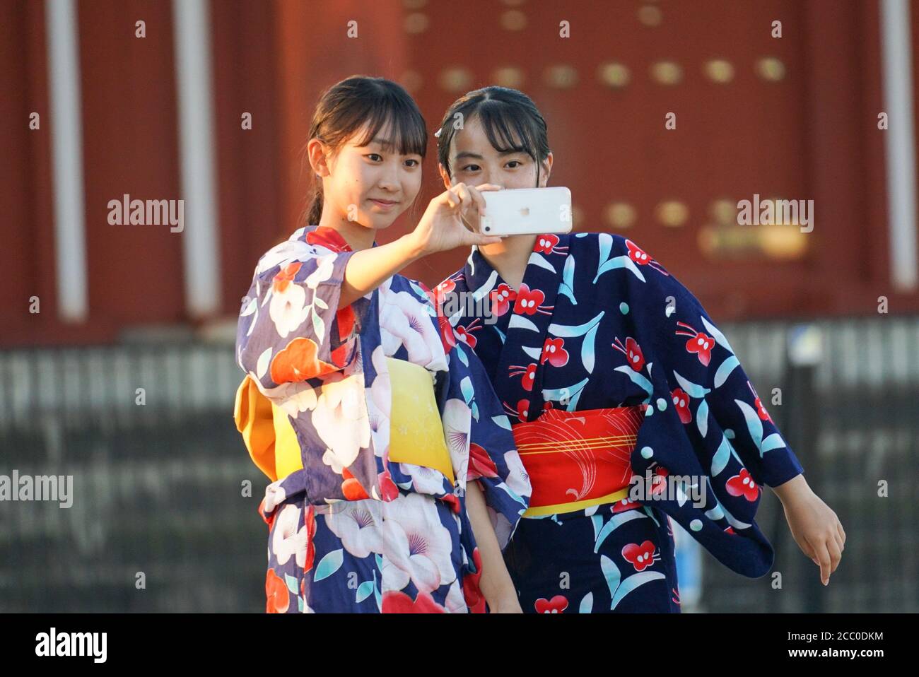 Nara, Japan. 16th Aug, 2020. Girls wearing yukata robes taking selfies  during the Nara festival. The festival has been transformed to a digital  projection art event amid coronavirus pandemic. Nara was the