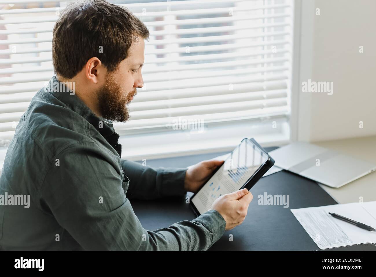Closeup director using tablet and looking at graphs on screen. Stock Photo