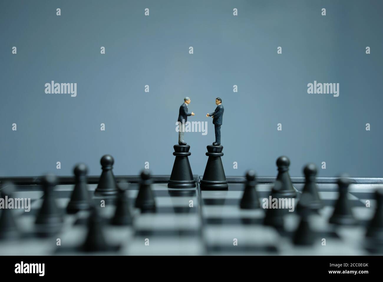 Image of chess game. Businessman looking at compass and pawns
