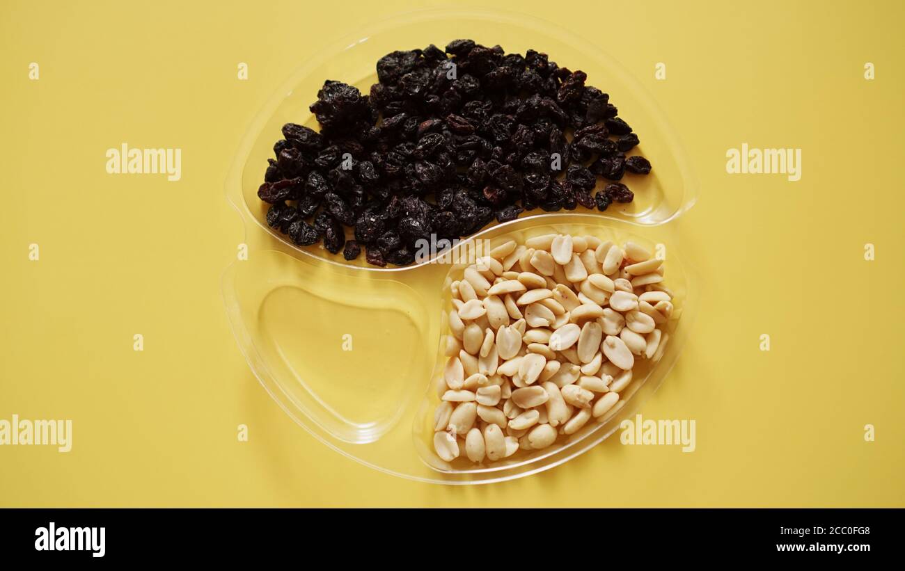 Dry fruits and nuts in round plastic container for food storage