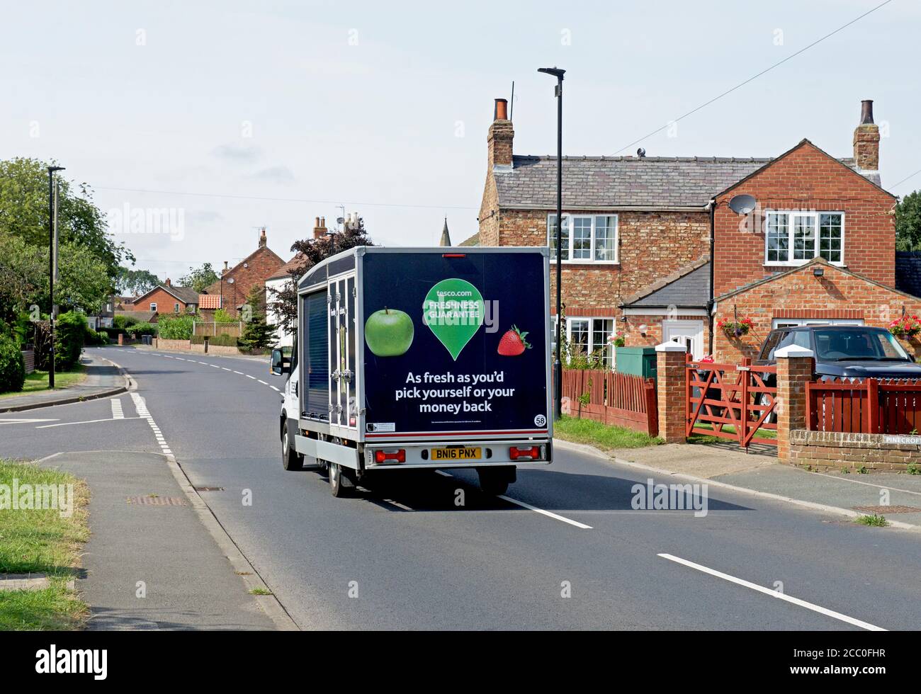 Tesco delivery van in the village of Rufforth, North Yorkshire, England UK Stock Photo