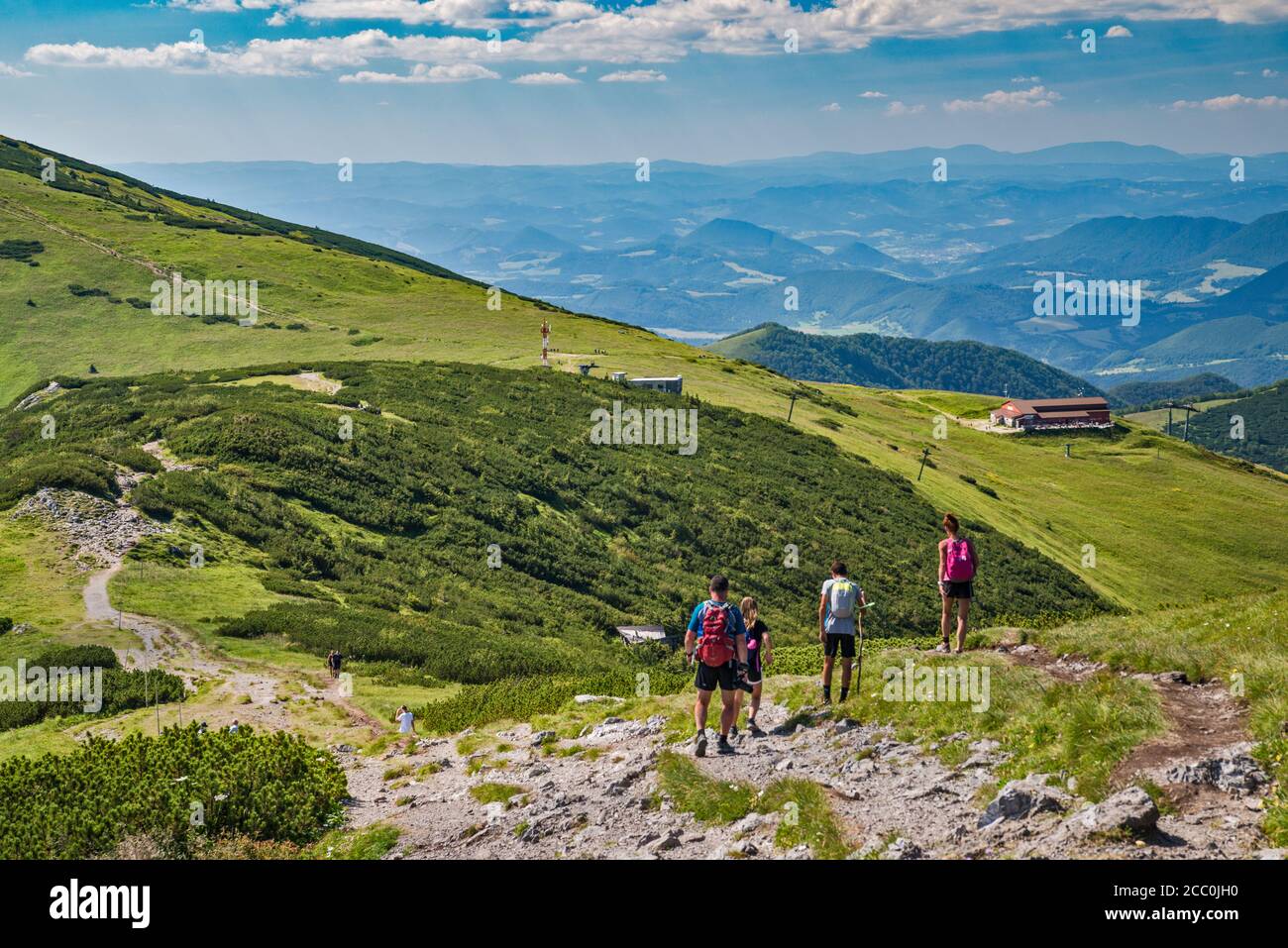 Velky Krivan massif on left, upper station of Vratna Chleb cable car, hikers on Chleb summit trail, Mala Fatra National Park, Zilina Region, Slovakia Stock Photo
