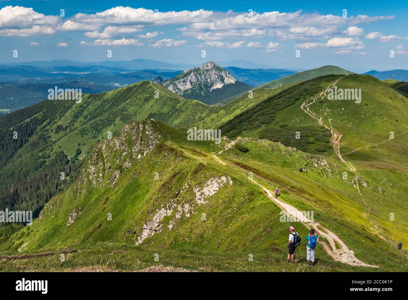 Velky Rozsutec mountain in far distance, Stoh massif on right, hikers, view NE from summit of Chleb, Mala Fatra National Park, Zilina Region, Slovakia Stock Photo