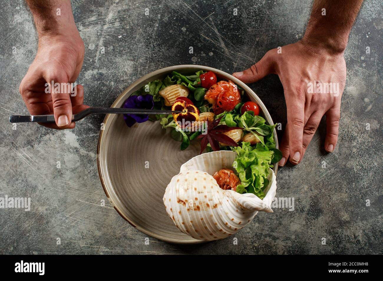 The chef prepares a salad of seafood and vegetables. Stock Photo