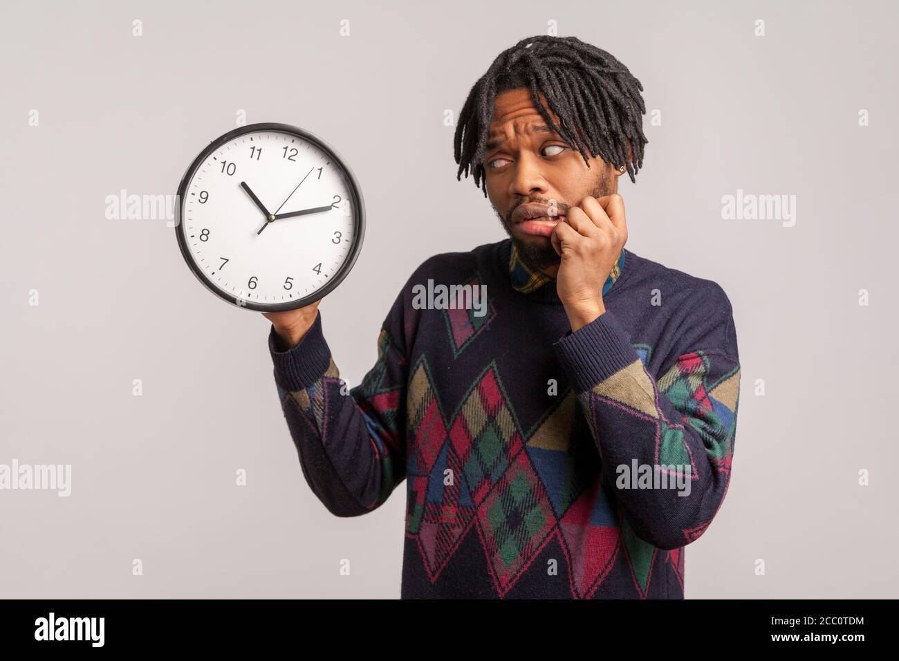 Time is out. Nervous scared african man in stylish sweatshirt anxiously ...