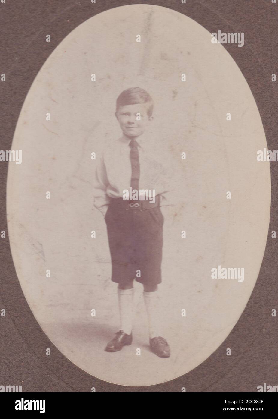 Vintage black and white photo of a young boy in school uniform 1920s Stock Photo